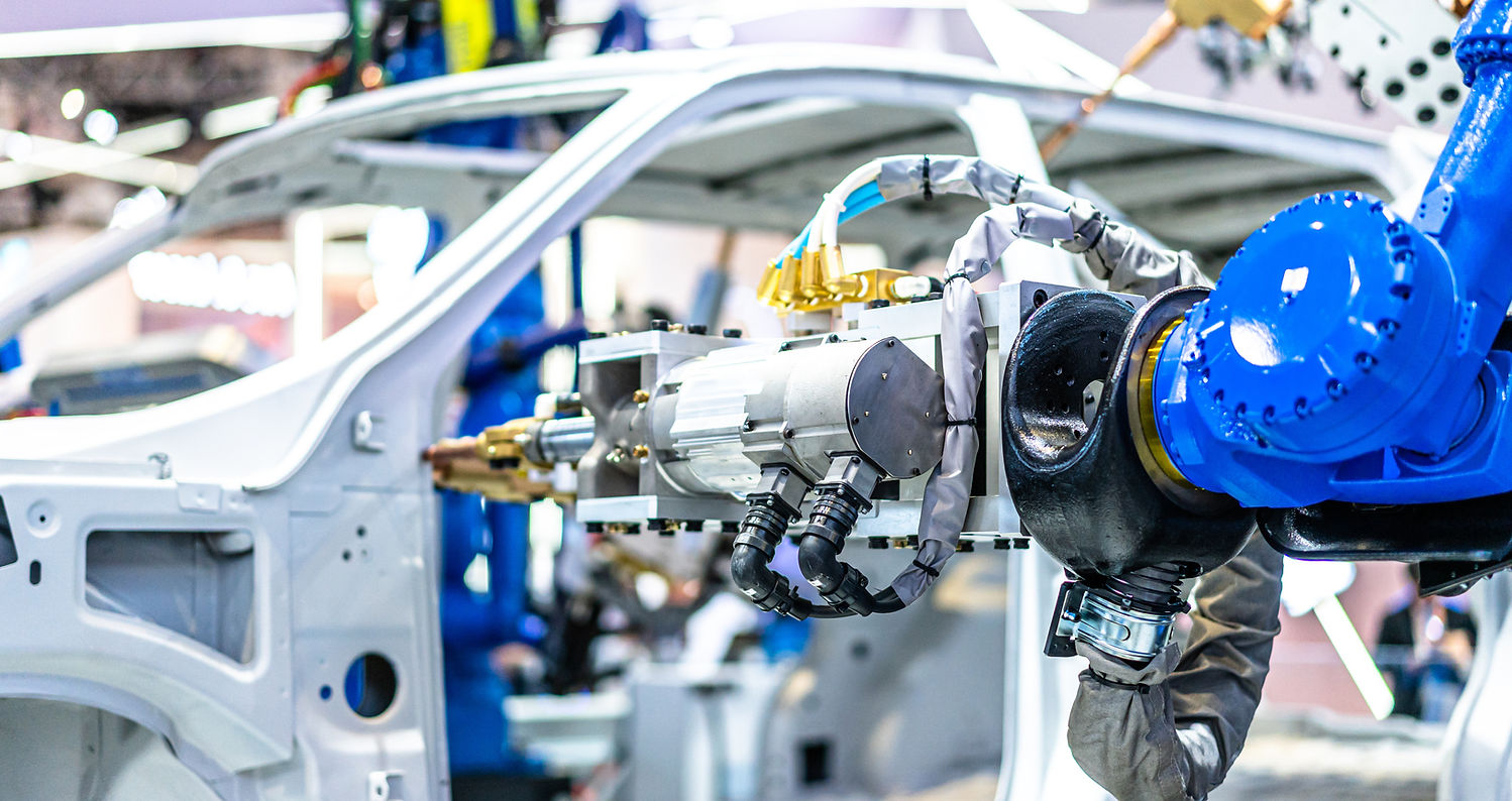 Blue robotic arm assembling a vehicle body
